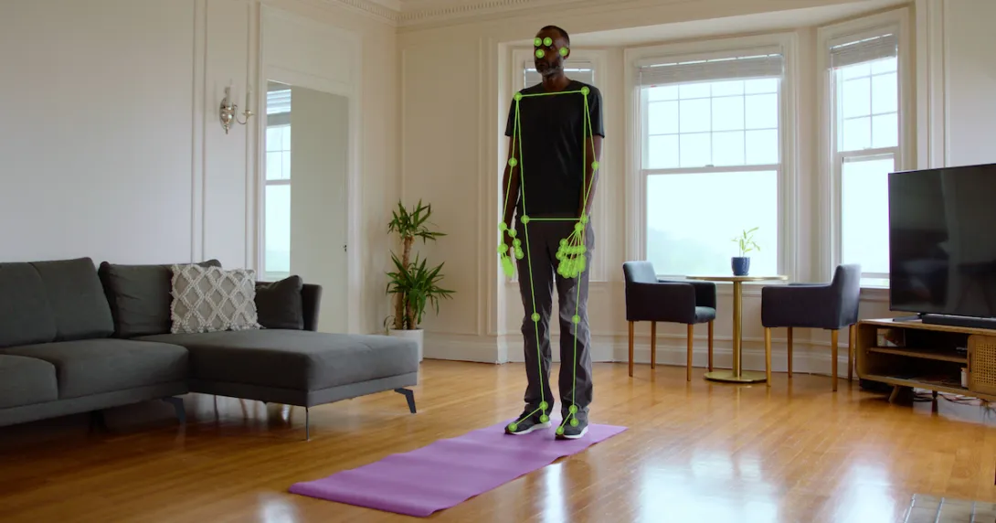 A man standing on a yoga mat while computer vision monitors his movement A man standing on a yoga mat while computer vision monitors his movement
