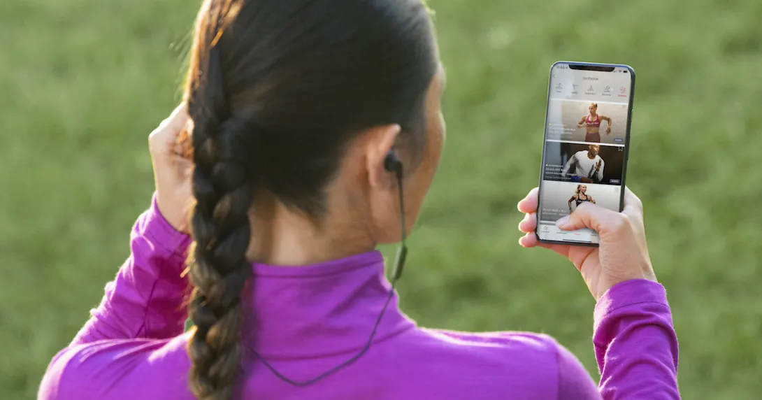Peloton user checks the app before going on a run