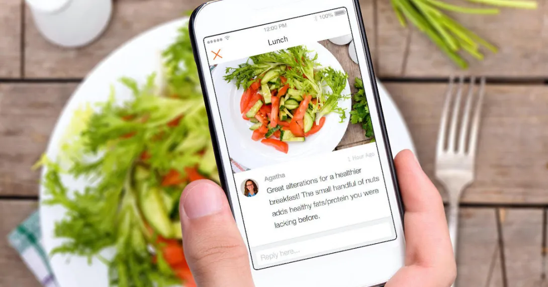 Yes Health user taking a picture of their salad lunch to share with their health coach
