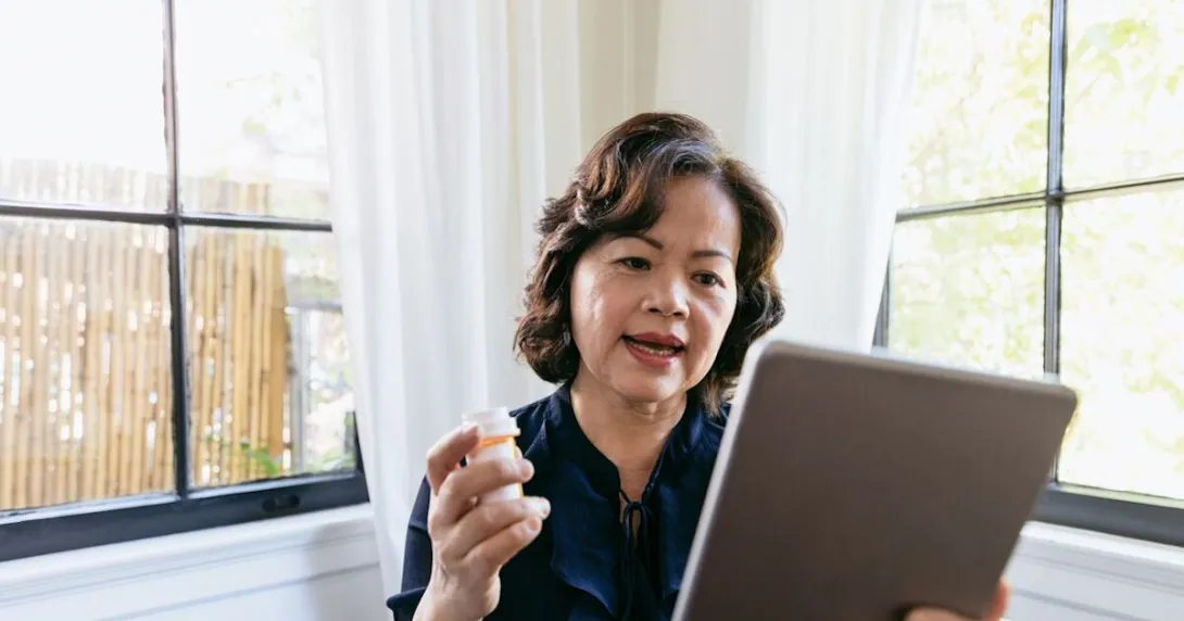 Person with pills at computer