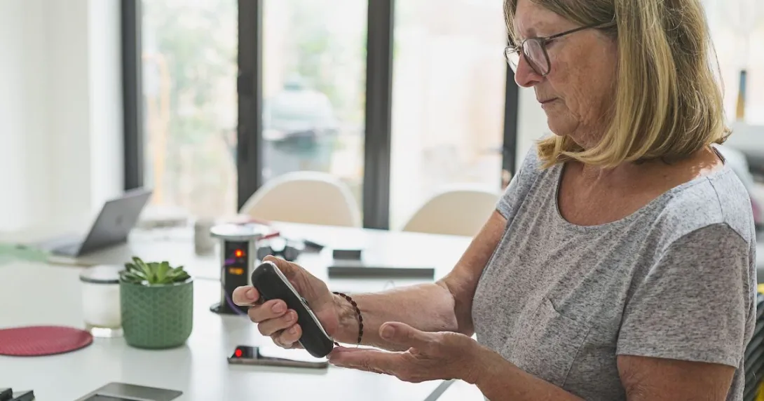 A woman checking her blood sugar. A woman checking her blood sugar.