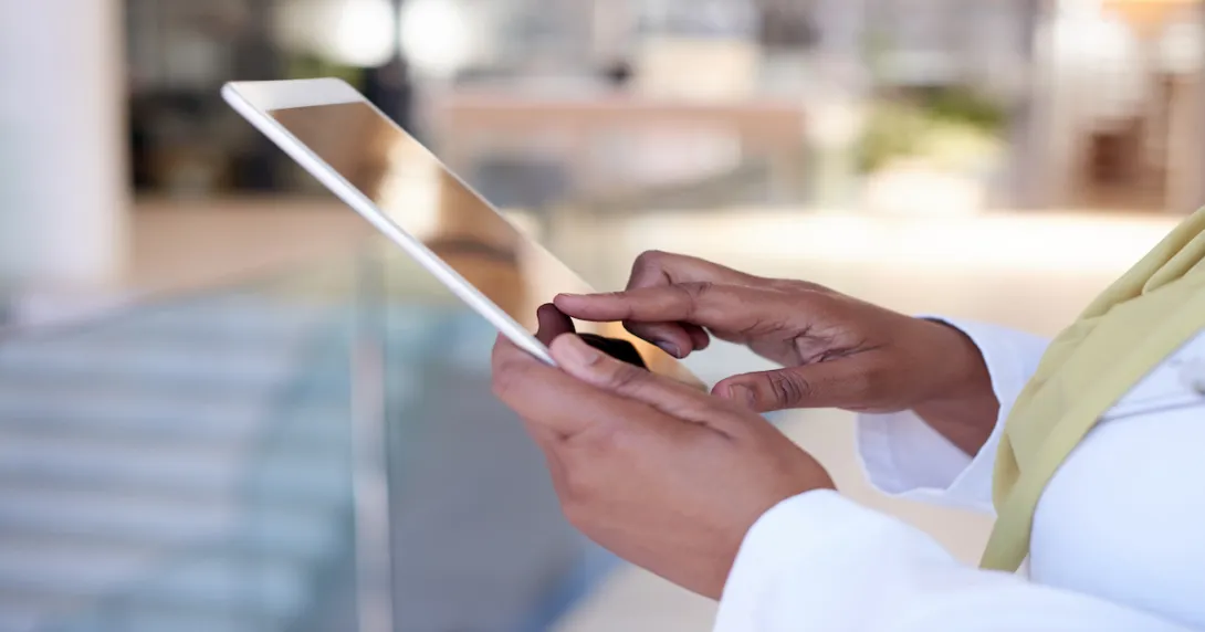 A close up photo of a woman using a tablet. A close up photo of a woman using a tablet.