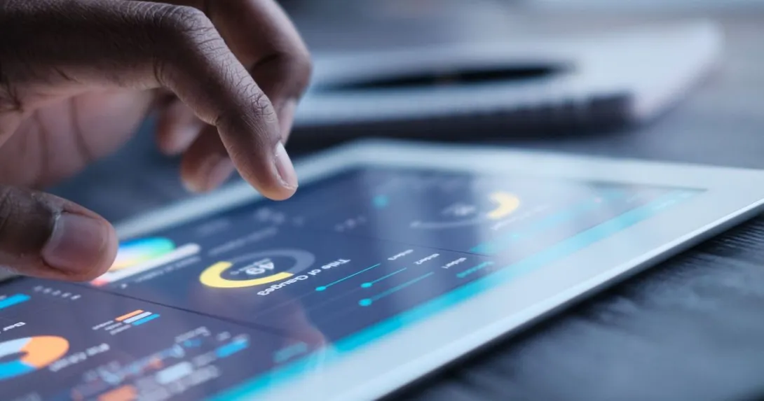 A close up of a person using a tablet displaying data and charts A close up of a person using a tablet displaying data and charts