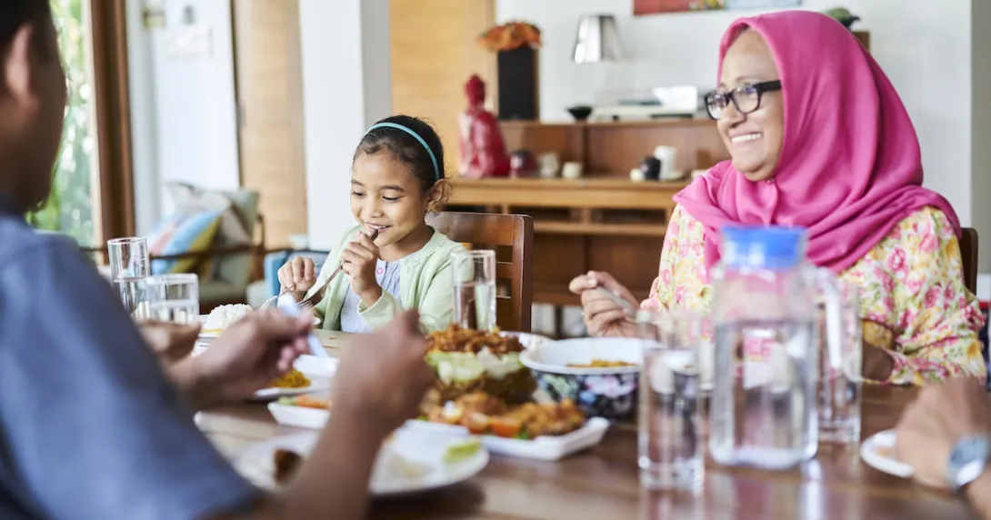 A family eating a meal together. A family eating a meal together.