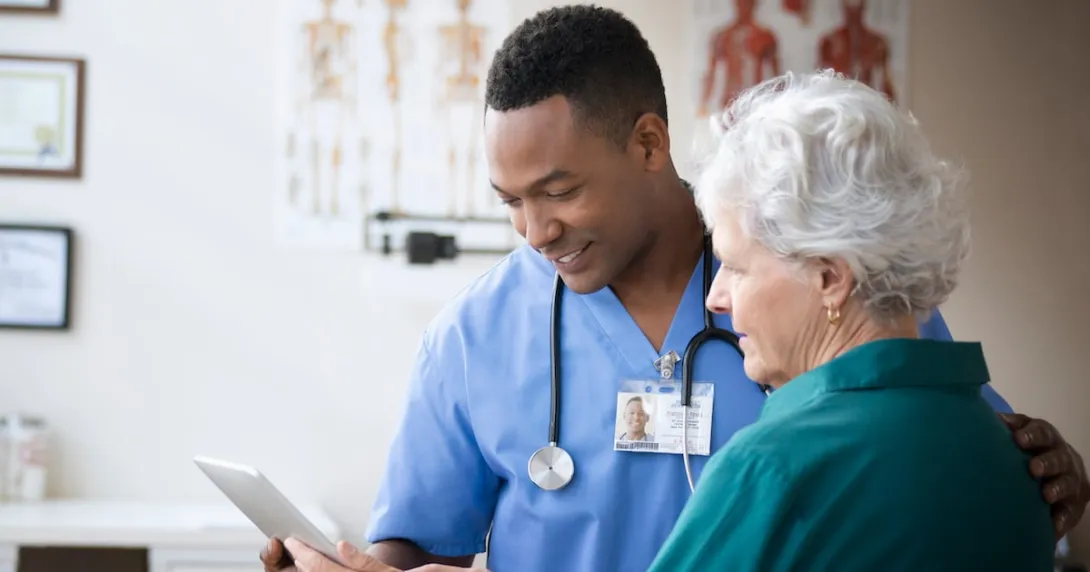 A doctor looking at a tablet with a patient. A doctor looking at a tablet with a patient.