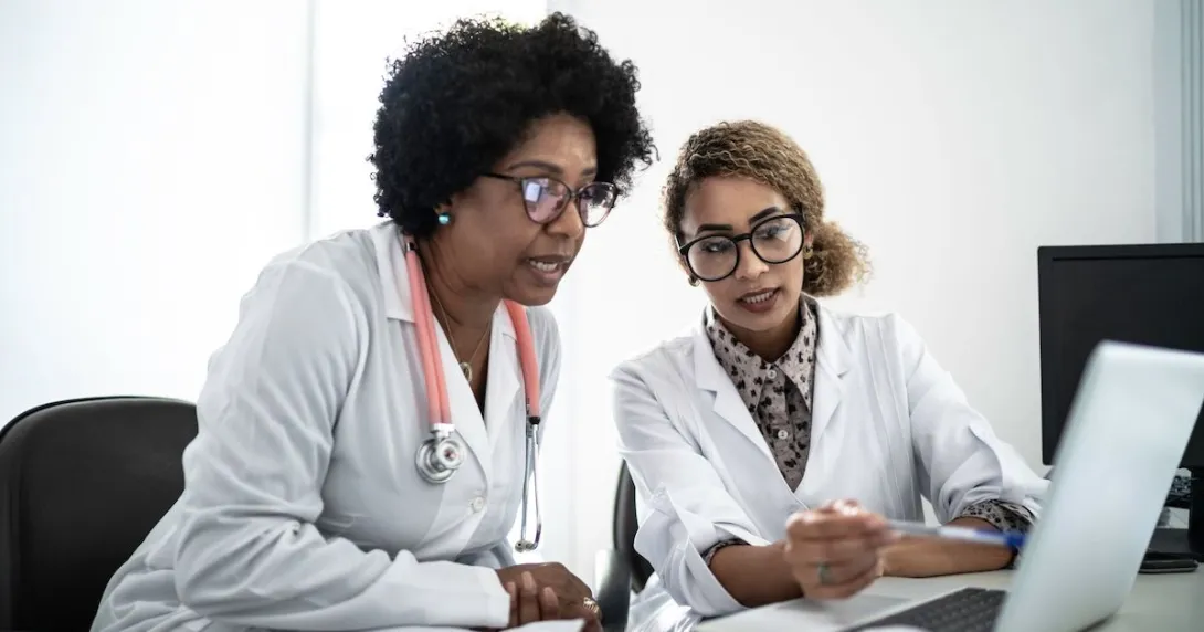 Two doctors looking at data on a laptop Two doctors looking at data on a laptop
