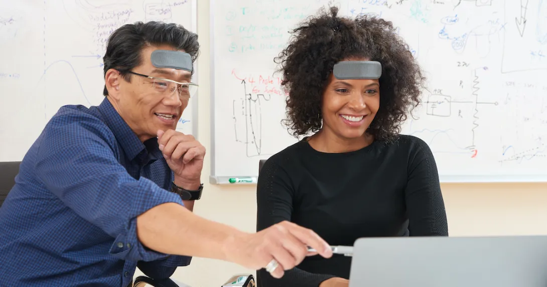 Two people wearing humm "learnable" patch working on a project