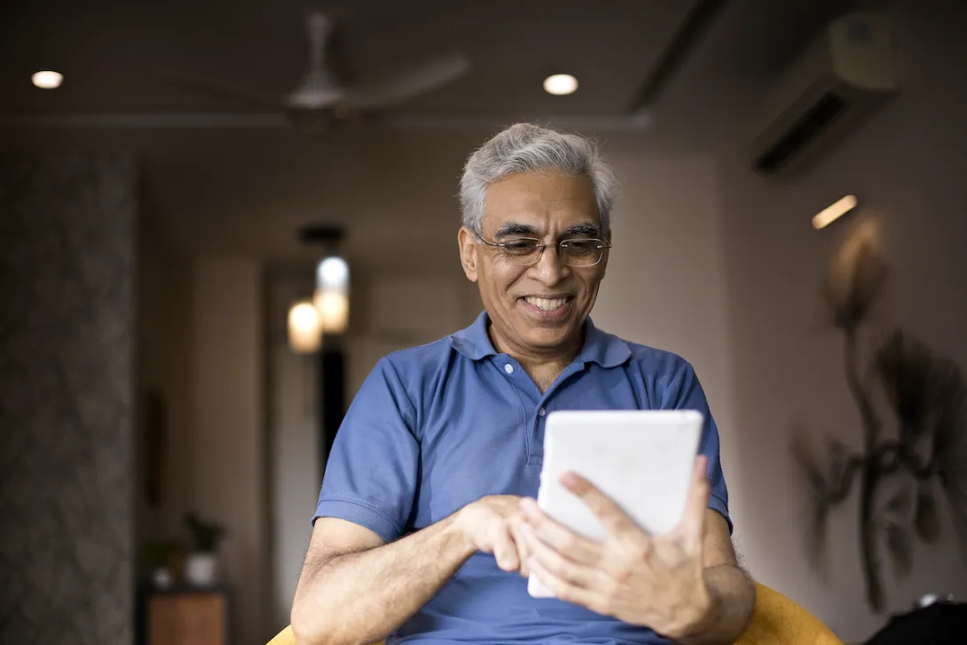 An older man using a tablet An older man using a tablet