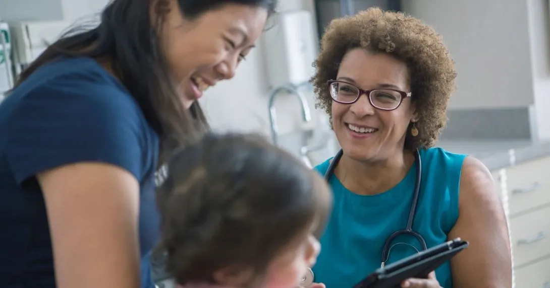 A parent and a child talking to a doctor A parent and a child talking to a doctor