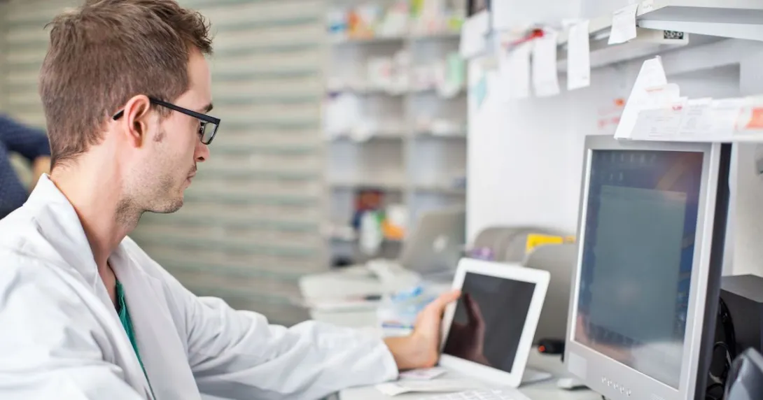 A pharmacist working at a desk A pharmacist working at a desk