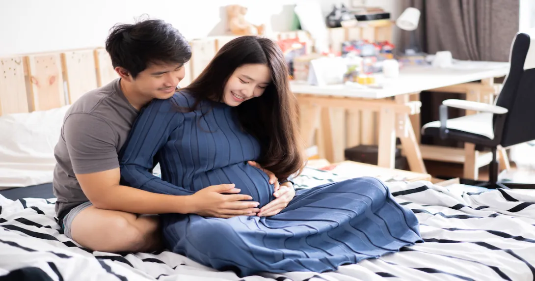 A pregnant woman and her partner A pregnant woman and her partner