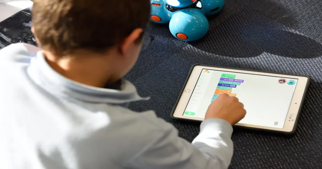 Alt text: A child playing on an iPad
