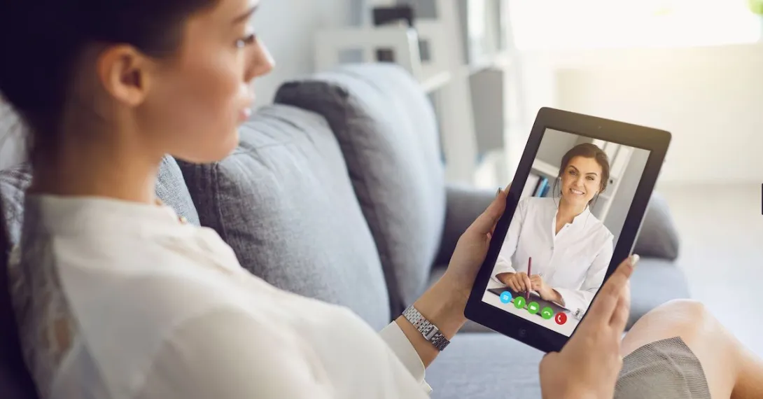 A person talks with a provider using a tablet A person talks with a provider using a tablet