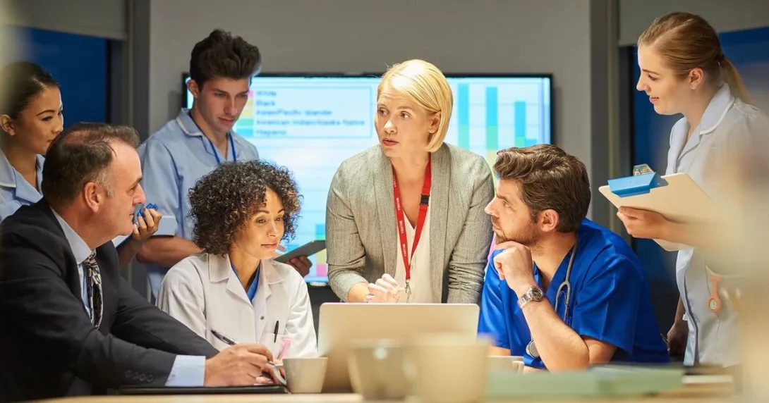 Healthcare and business professionals in an in-person conference meeting