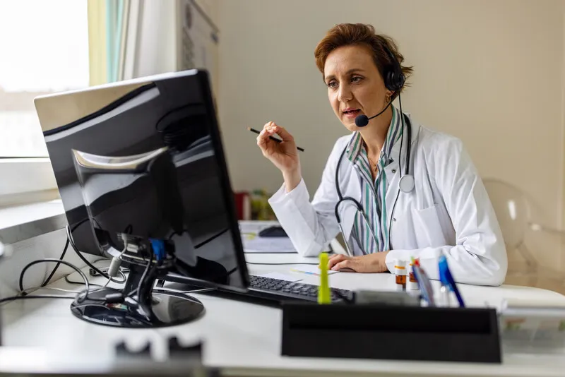 A doctor speaking to a patient on a video call.