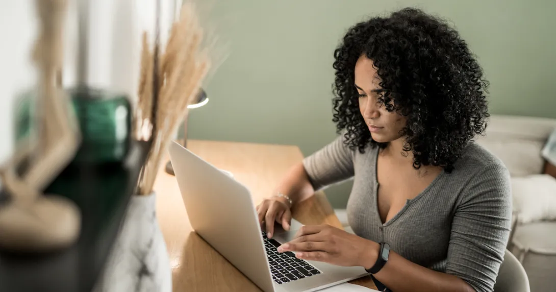 A person using a laptop. A person using a laptop.