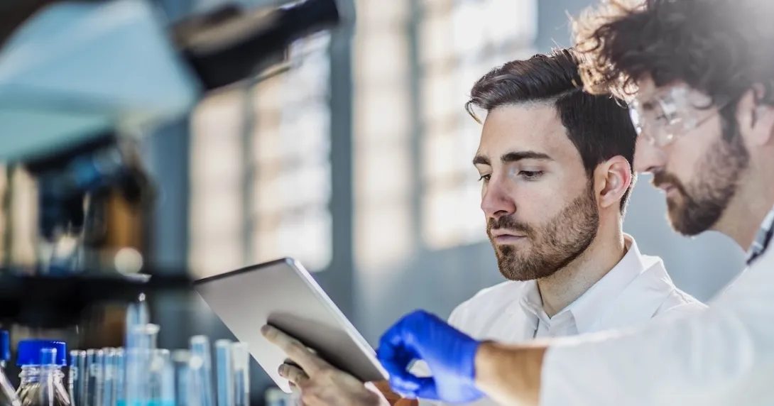 Two researchers looking at a tablet computer
