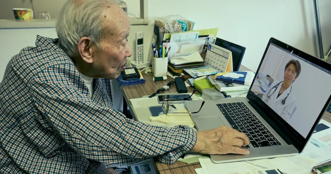 Senior adult consulting with healthcare professional via laptop computer