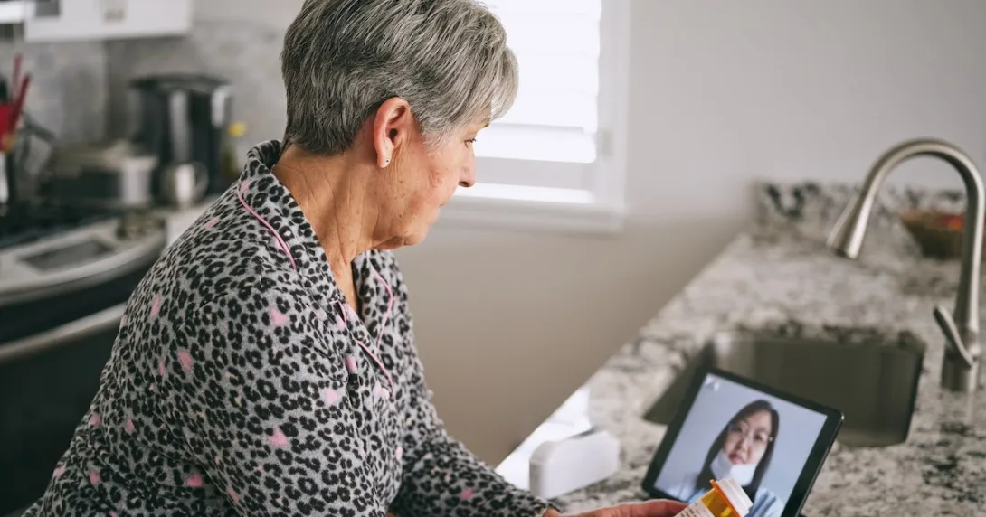 Patient interacting with healthcare professional via tablet