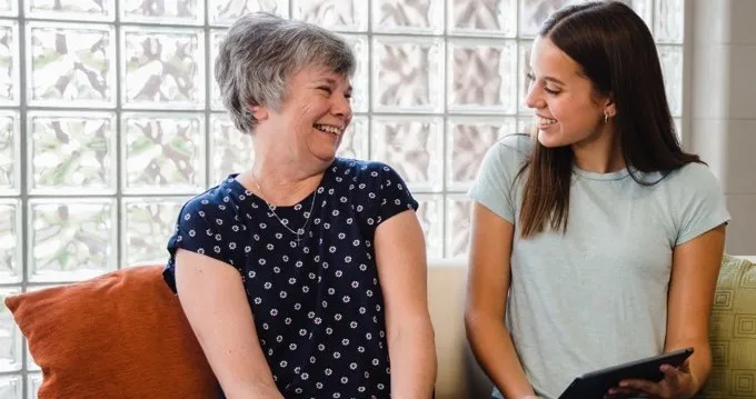 A woman using the LifeBio app with a caregiver
