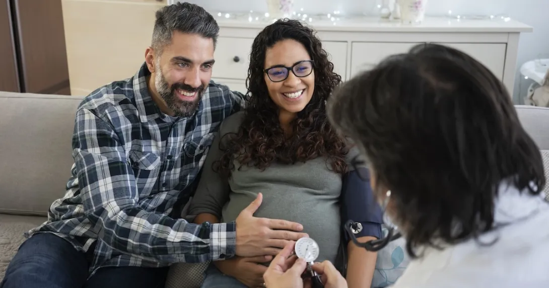 Couple, pregnant women consulting with a healthcare professional