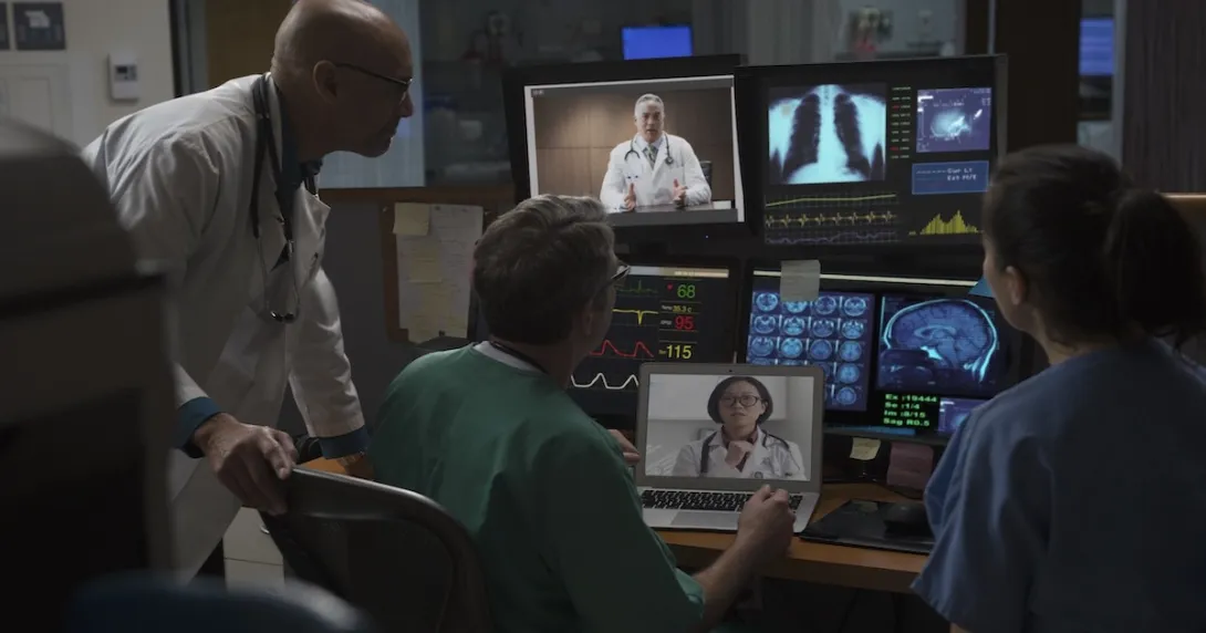 Healthcare professionals reviewing data on computer screens