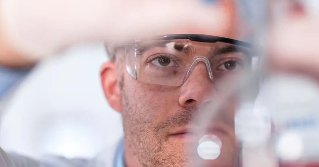 Clinician examining the contents of a test tube