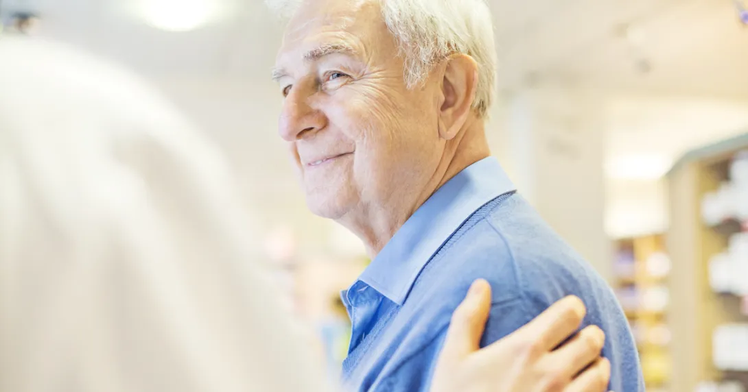 Person with a hand on his shoulder