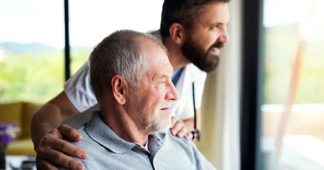 An older man with a caregiver