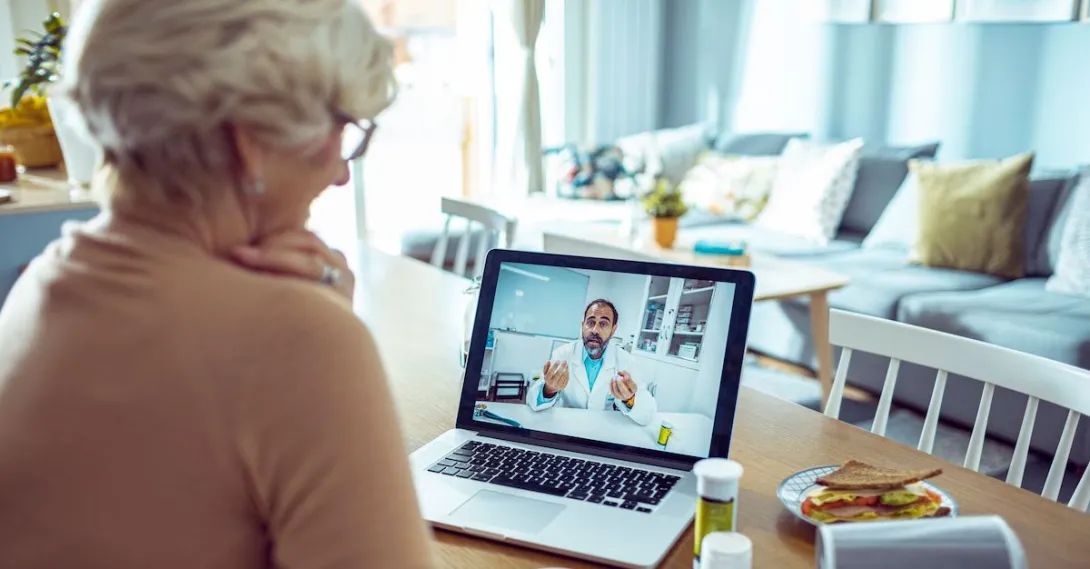 An older woman talking a doctor via telehealth