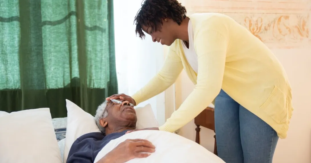 A patient in bed with an attendant nurse