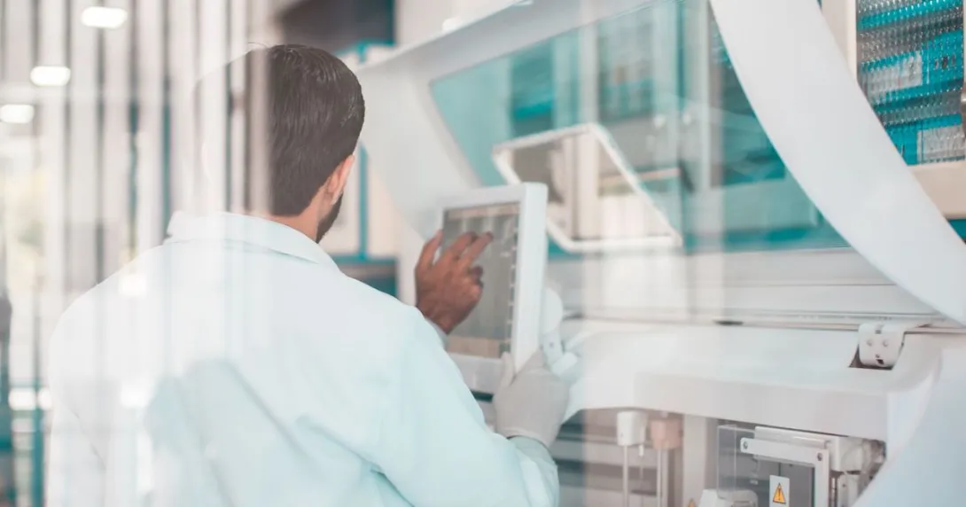 Healthcare researcher looking at a computer while in a lab