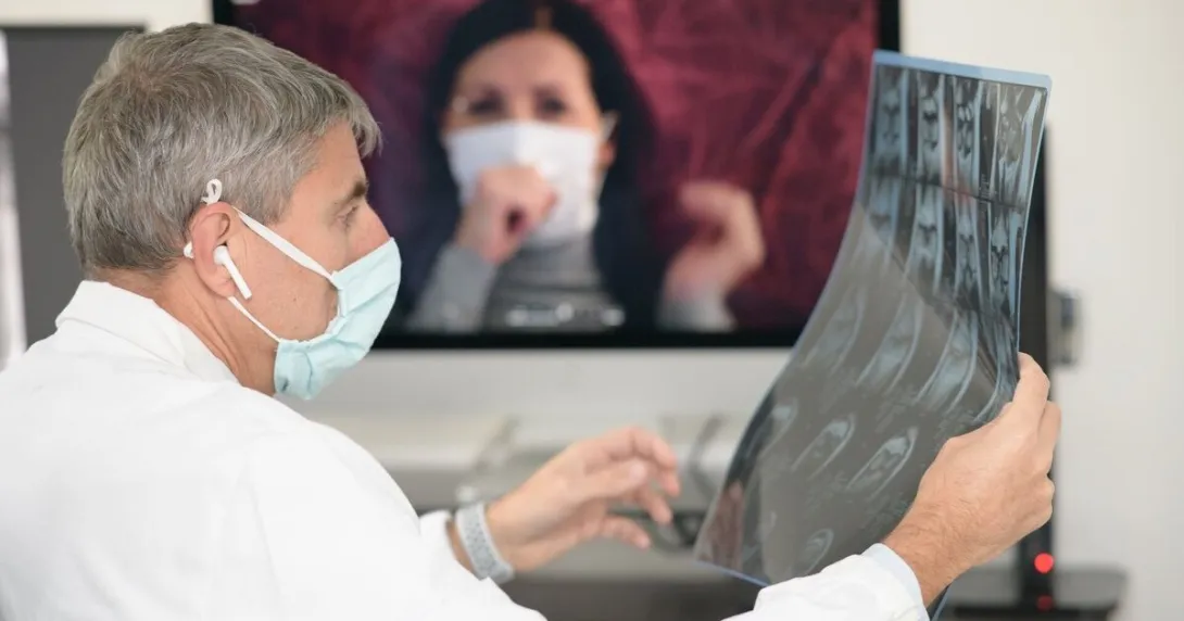 A physician looking at an x-ray image while in video consultation