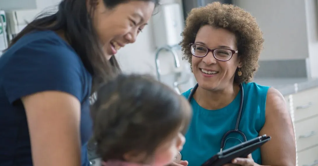A mother and her child in a consultation with a doctor.